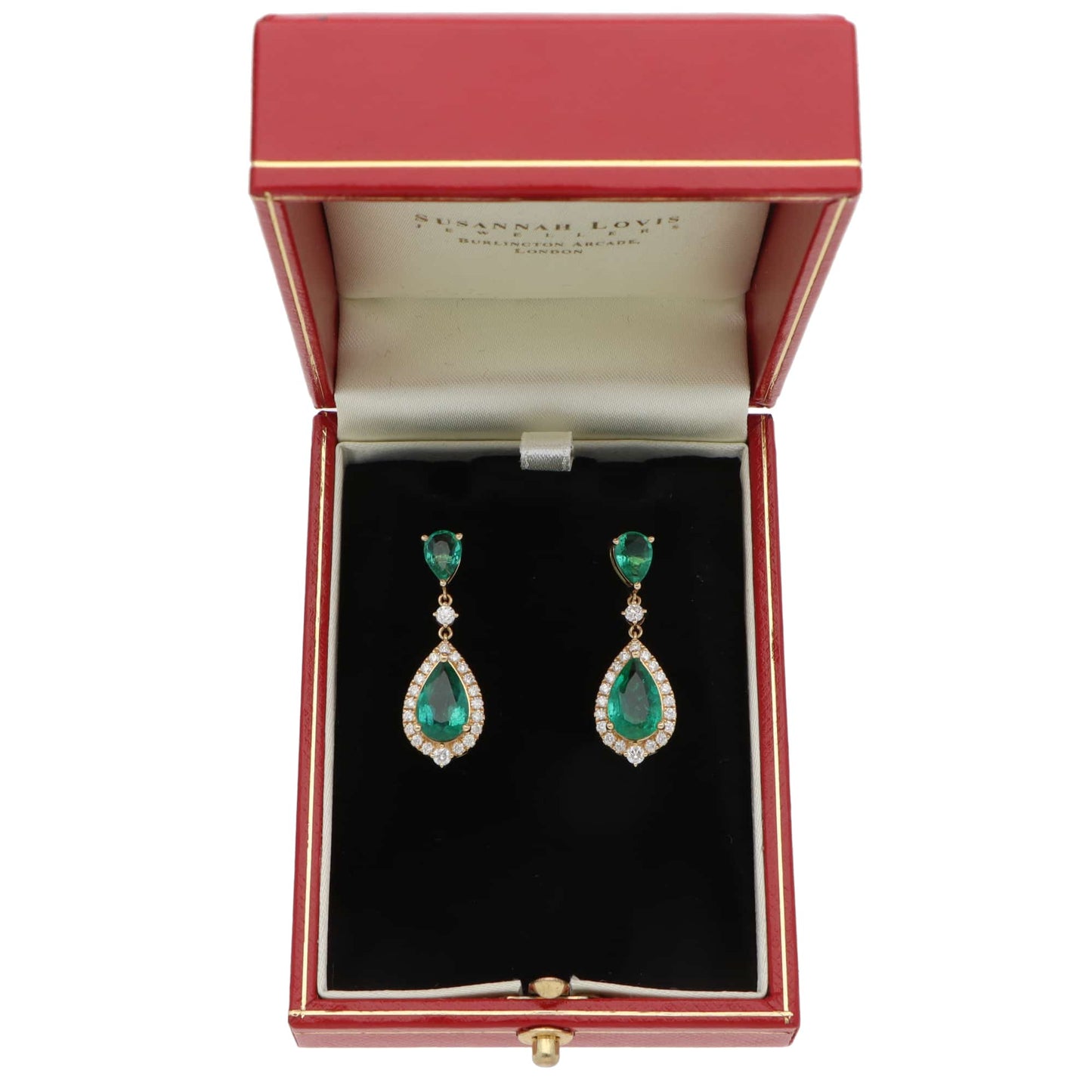 A pair of emerald and diamond cluster drop earrings in yellow gold, in a red box, on a white background