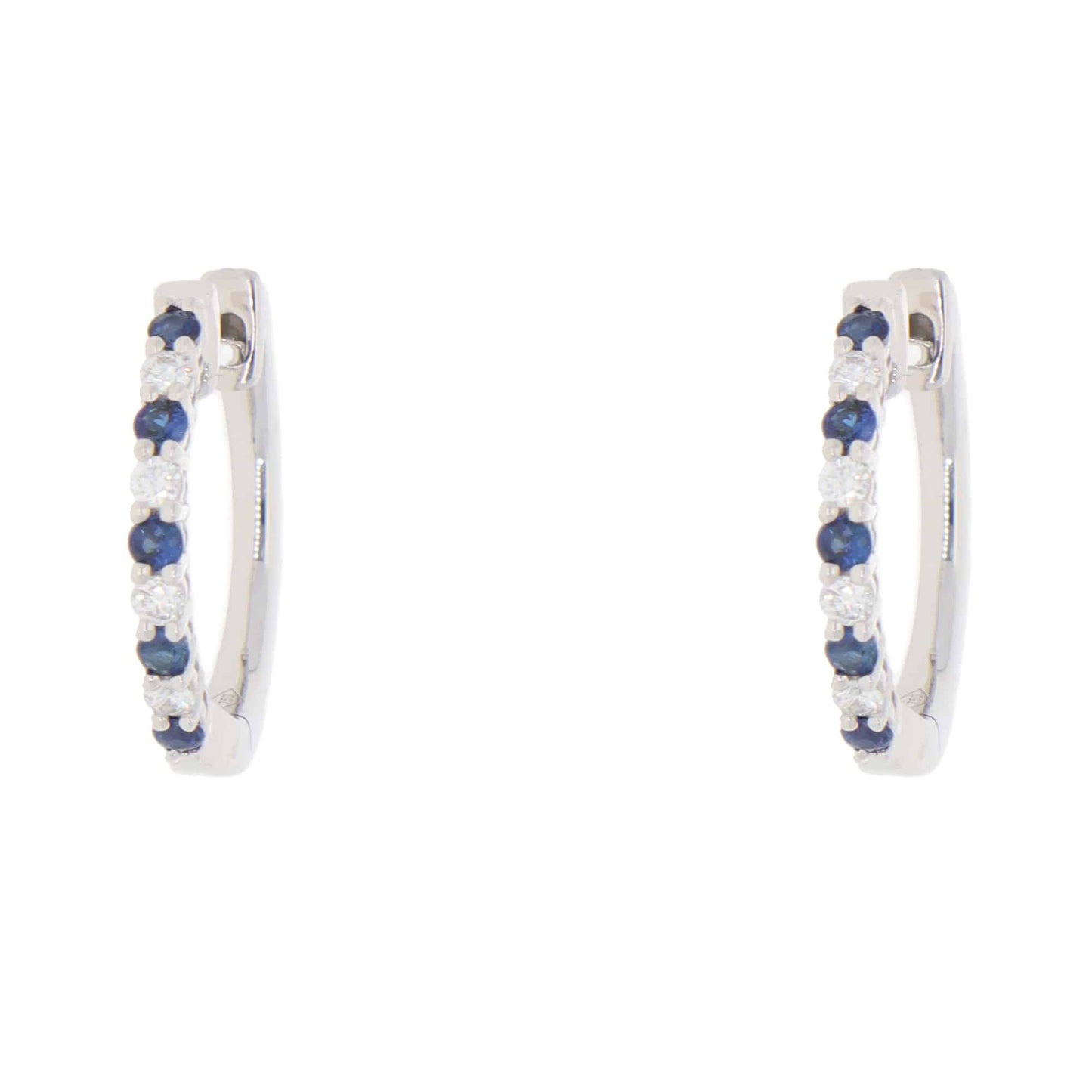 A pair of white gold hoop earrings set with round sapphires and diamonds, on a white background