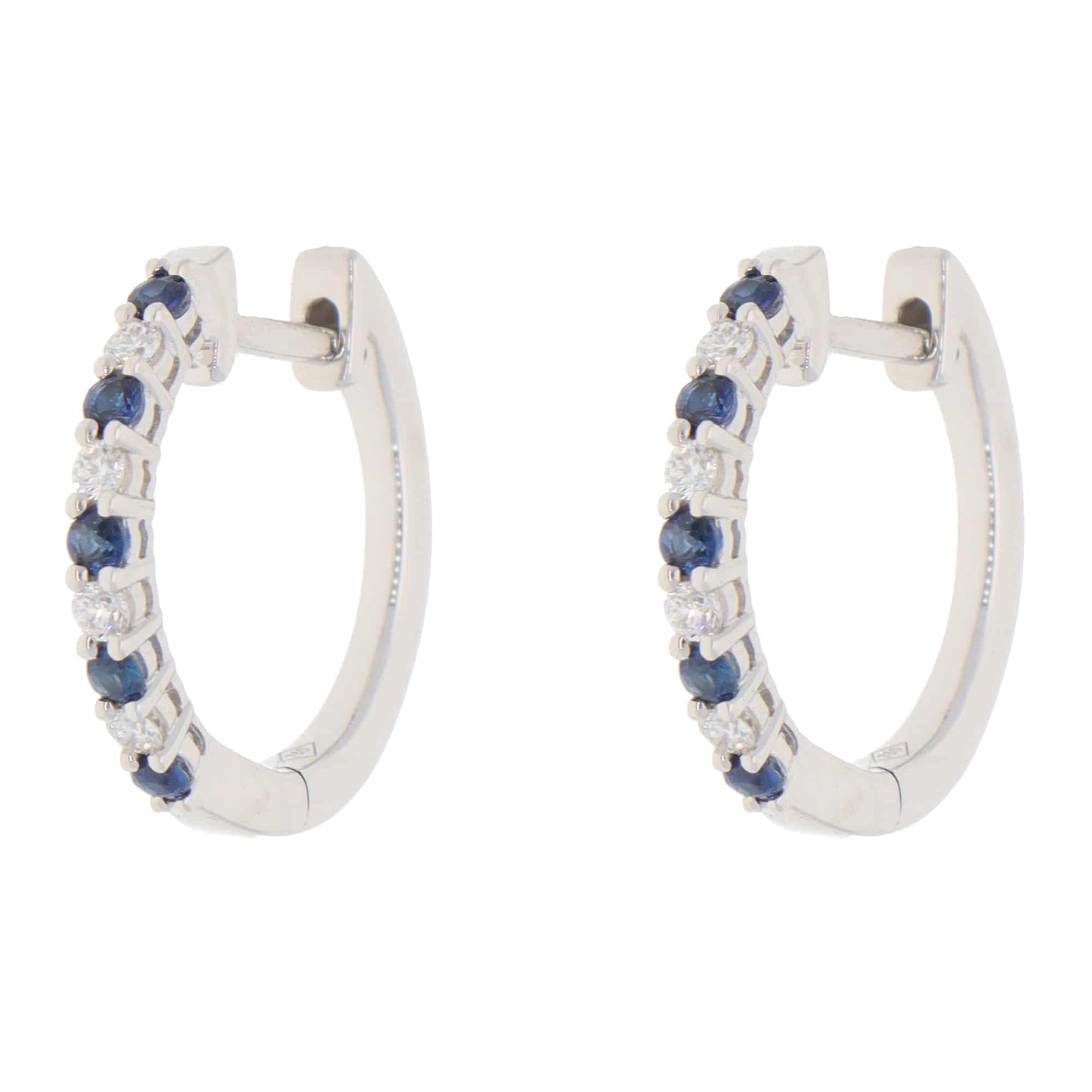 A pair of white gold hoop earrings set with round sapphires and diamonds, on a white background