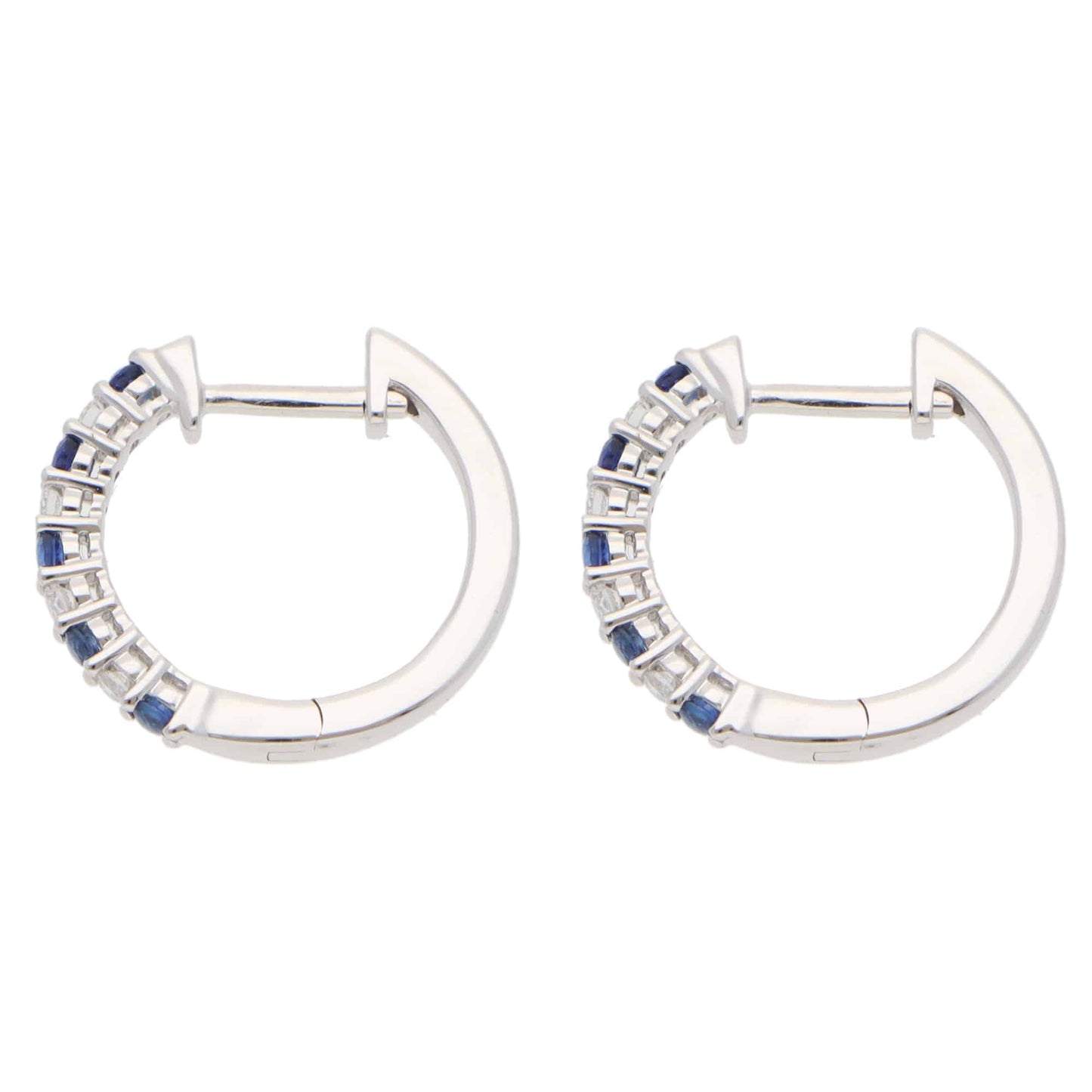 A pair of white gold hoop earrings set with round sapphires and diamonds, on a white background