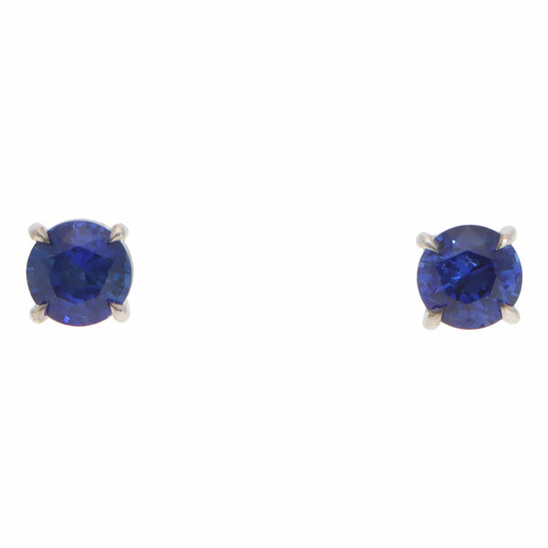 A pair of blue sapphire single stone stud earrings in white gold, on a white background