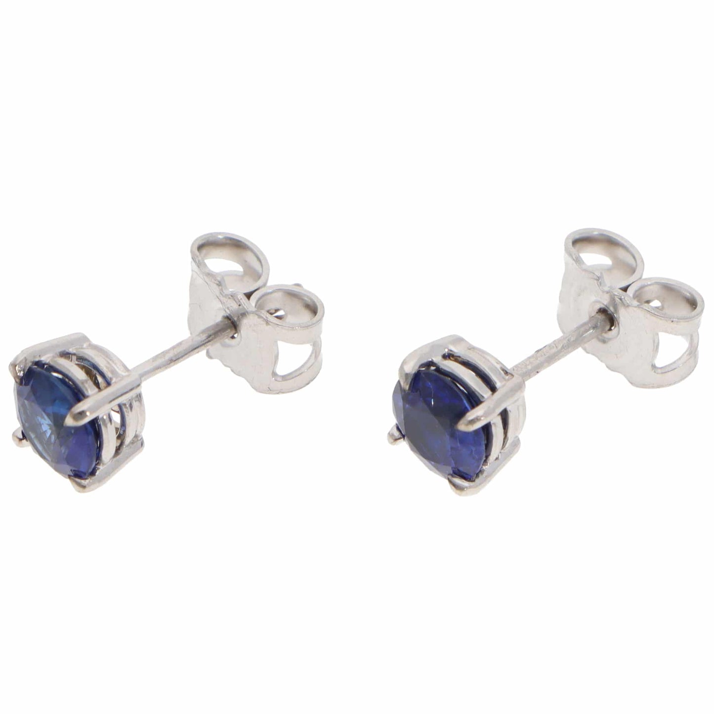 A pair of blue sapphire single stone stud earrings in white gold, on a white background