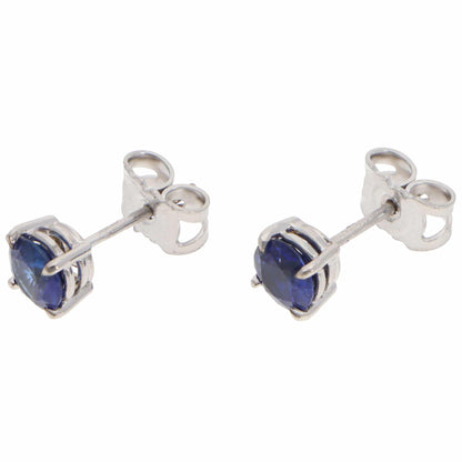 A pair of blue sapphire single stone stud earrings in white gold, on a white background