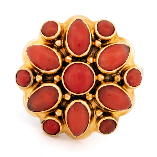 A yellow gold and coral flower design cluster ring
