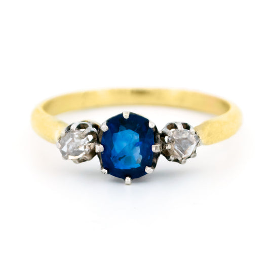 A three stone sapphire and diamond ring in gold and silver