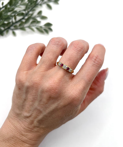 A yellow gold ruby and diamond five stone ring, modelled on a hand