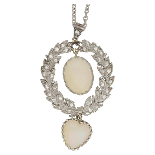 Antique Belle Epoque Opal and Diamond Wreath Pendant; oval cabochon white opal within rose-cut diamond-set platinum wreath suspending a heart-shape cabochon white opal, in platinum and gold
