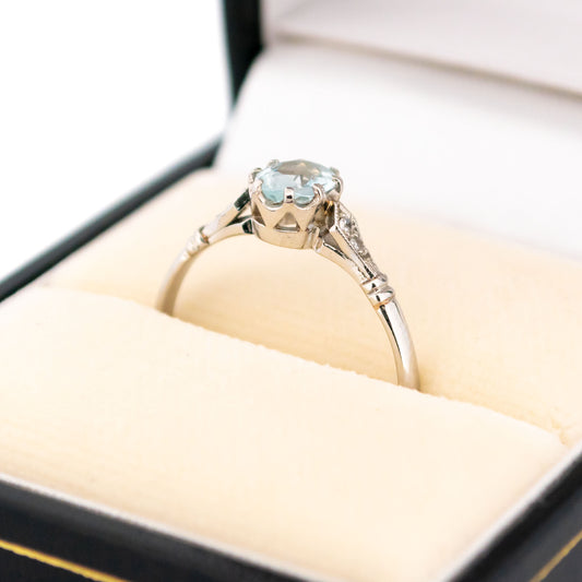 A platinum aquamarine and diamond ring, in a ring box