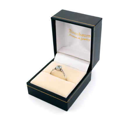 A platinum aquamarine and diamond ring, in a ring box