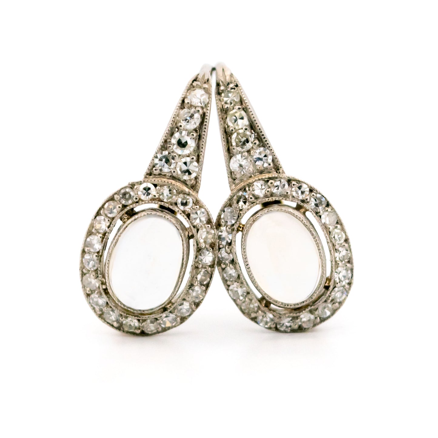 A pair of moonstone and diamond drop earrings in platinum and gold