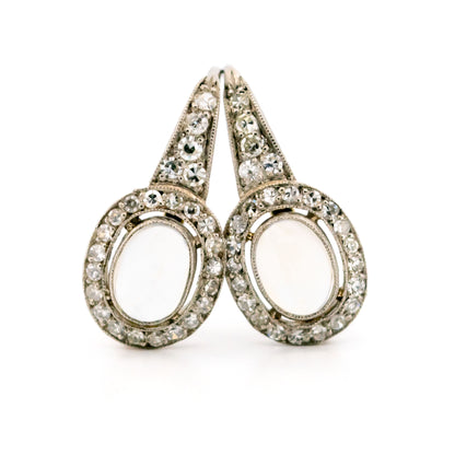 A pair of moonstone and diamond drop earrings in platinum and gold