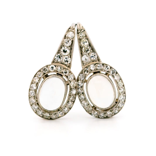 A pair of moonstone and diamond drop earrings in platinum and gold