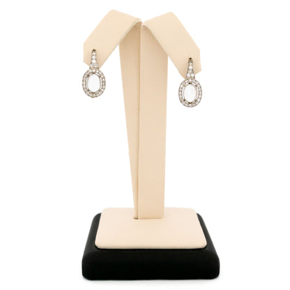 A pair of moonstone and diamond drop earrings in platinum and gold