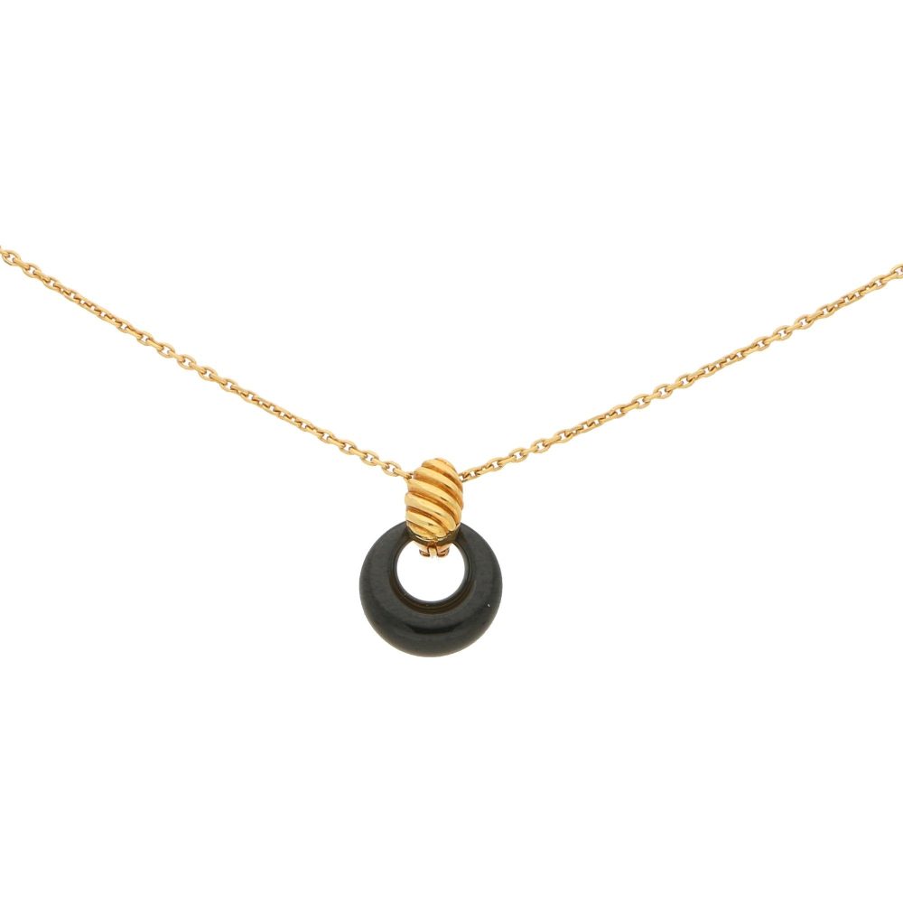 Van Cleef & Arpels onyx disk pendant necklace in gold.