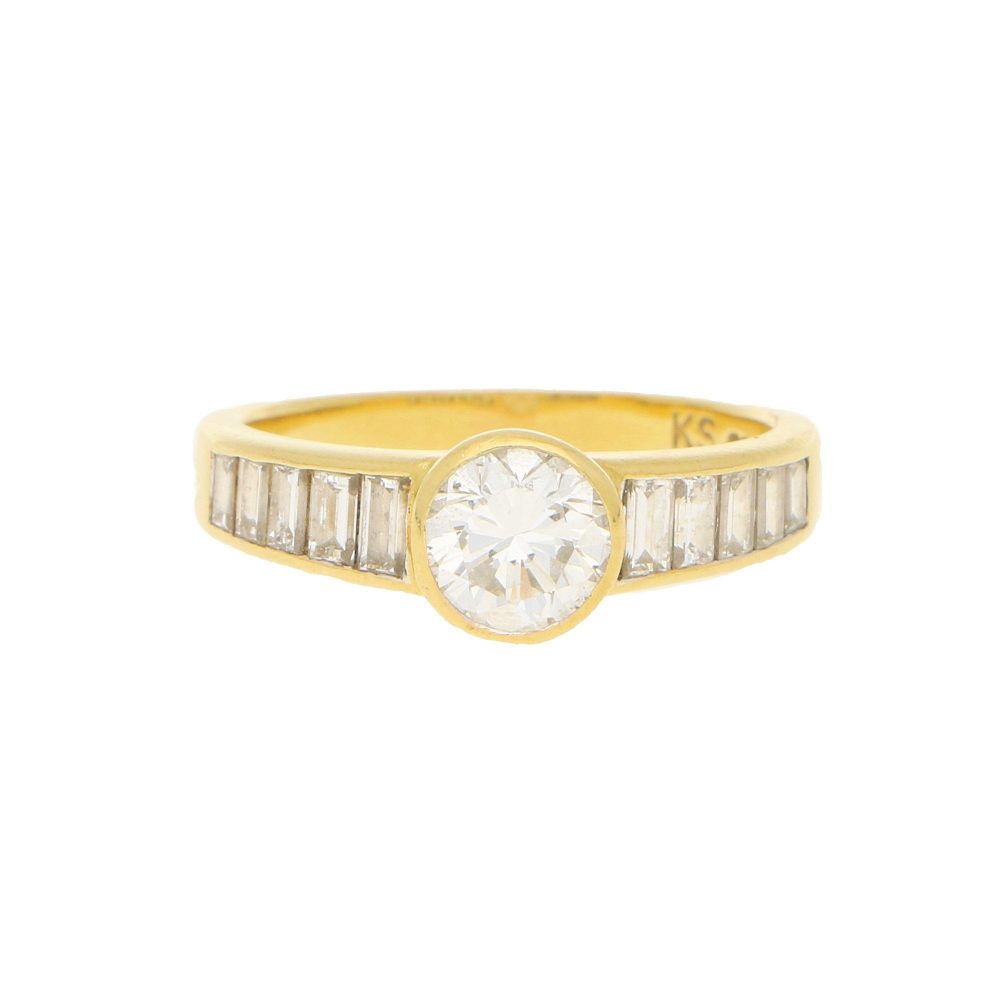 Contemporary 1ct Diamond Ring with Baguette Shoulders; central collet-set 1ct round brilliant-cut diamond flanked to each side by 1ct graduated baguette-cut diamonds in 18ct yellow gold