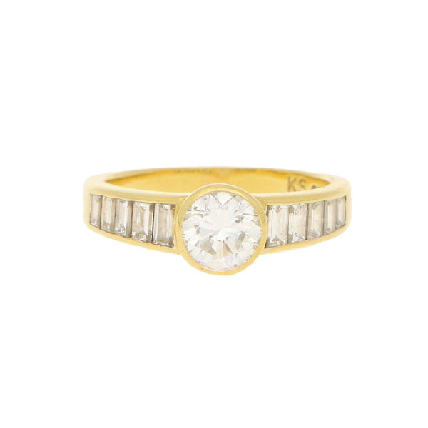 Contemporary 1ct Diamond Ring with Baguette Shoulders; central collet-set 1ct round brilliant-cut diamond flanked to each side by 1ct graduated baguette-cut diamonds in 18ct yellow gold