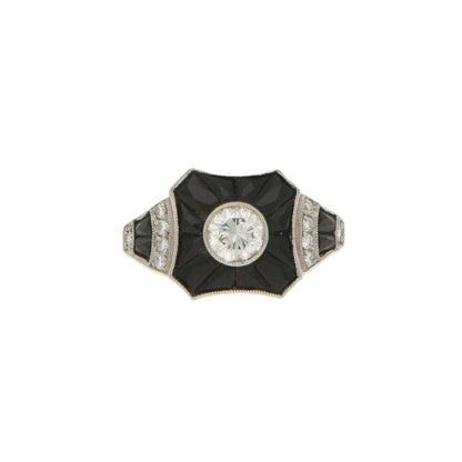 0.50ct Diamond and Onyx Target Ring in Platinum; central 0.50 carat round brilliant-cut diamond surrounded by calibre-French-cut onyx, tapered shoulders embellished with diamonds and onyx flowing to a solid D-shape platinum shank