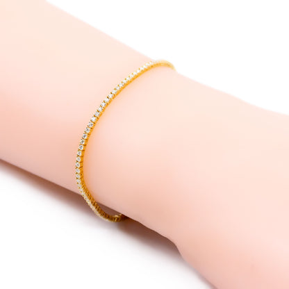 A yellow gold diamond line bracelet, modelled on a wrist