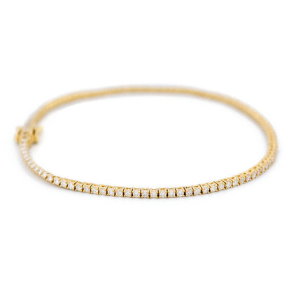 A yellow gold diamond line bracelet