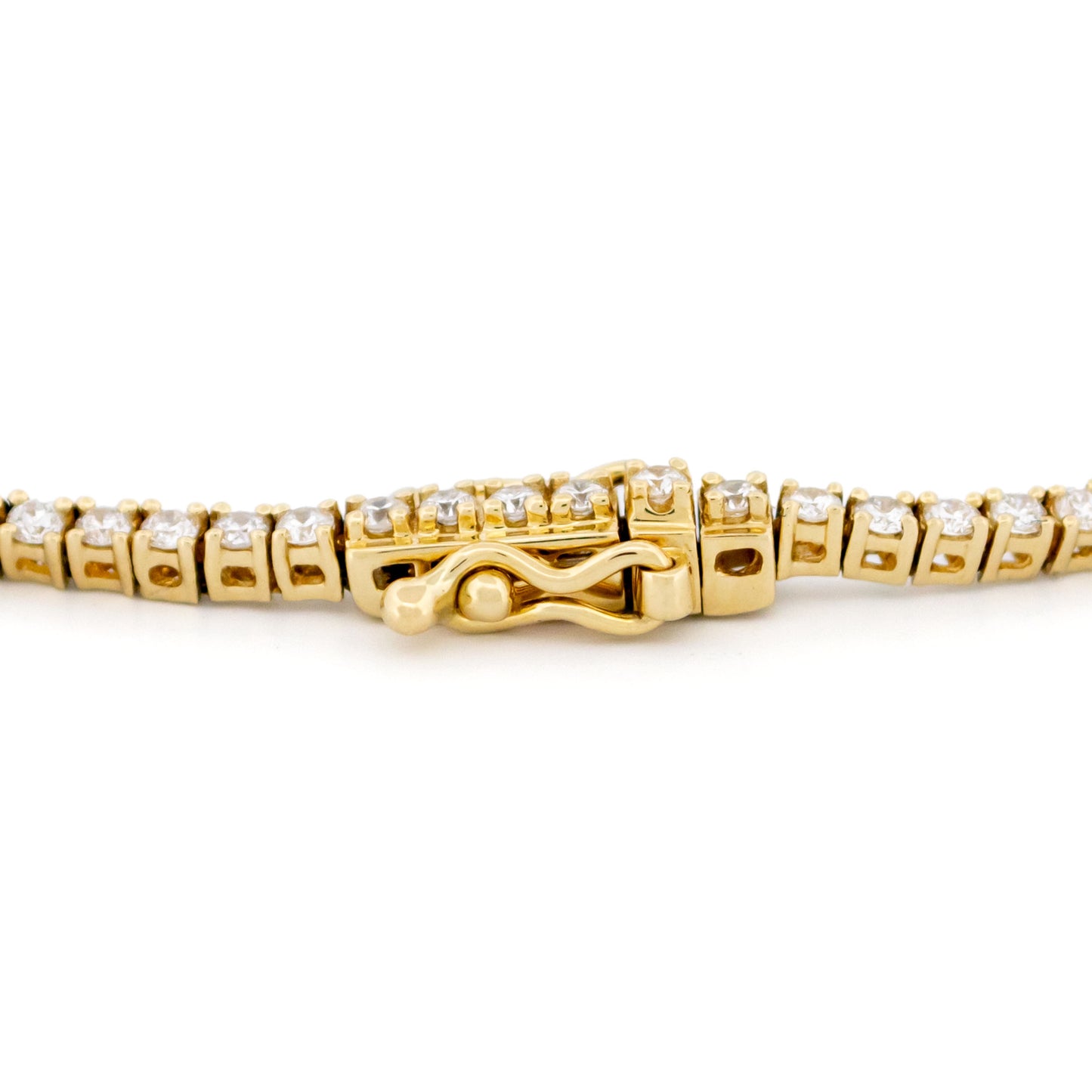 A yellow gold diamond line bracelet, close-up of the clasp