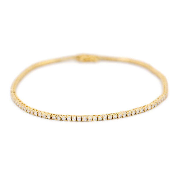 A yellow gold diamond line bracelet