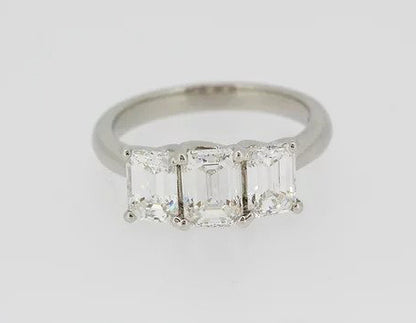 Emerald Cut 2.46ct Diamond Three Stone Ring in Platinum; a striking trilogy ring featuring three emerald-cut diamonds, 2.46 carats, Colour 'H', Clarity 'VS'