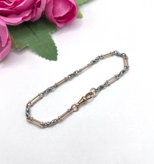 A yellow gold and platinum link bracelet with a lobster claw clasp