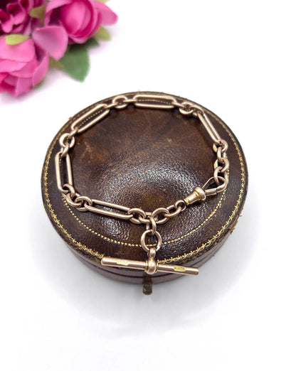 A rose gold link bracelet with a T-bar