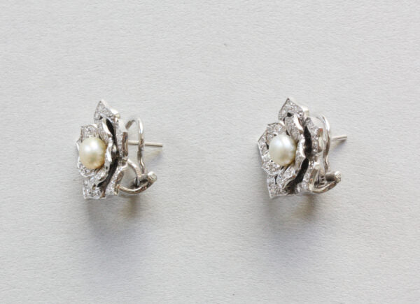 Diamond, Pearl and Enamel Lotus Flower Stud Earrings; pearl surrounded by diamond set leaves, enamel detailing, 14ct gold. Steltman, Netherlands, 2004