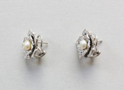 Diamond, Pearl and Enamel Lotus Flower Stud Earrings; pearl surrounded by diamond set leaves, enamel detailing, 14ct gold. Steltman, Netherlands, 2004