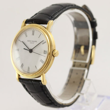 Patek Philippe 3802 Calatrava 18ct Yellow Gold 33mm Automatic, porcelain white dial, Roman numerals, date indicator at 3, calibre 310SC, Patek Phillipe black leather strap with 18ct Yellow Gold buckle, Circa 1991, in mint condition, with Patek Philippe pouch and papers.