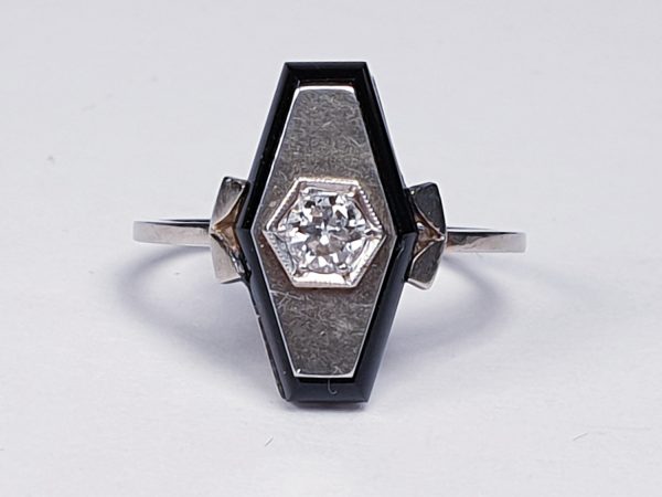 Art Deco French Old Cut Diamond and Onyx Lozenge Plaque Ring; hexagonal ring with central 0.25ct old cut diamond on a matt ground with a fine onyx border. Set in white gold, Circa 1925
