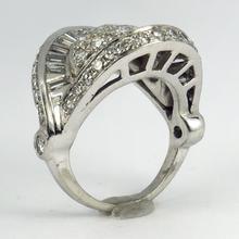 Retro Diamond and Platinum Cocktail Ring; designed as a dome with curved and flaring ridges, set with 2.55 carats round brilliant cut and baguette diamonds