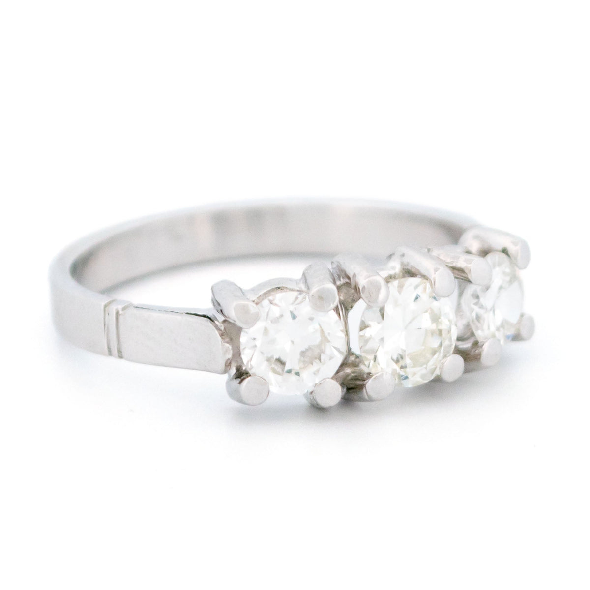A three stone round diamond ring claw set in platinum