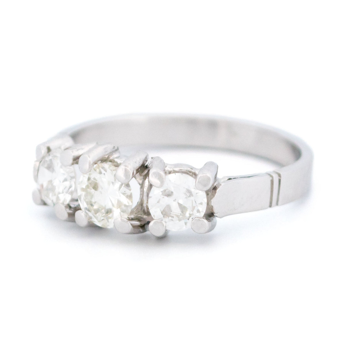 A three stone round diamond ring claw set in platinum