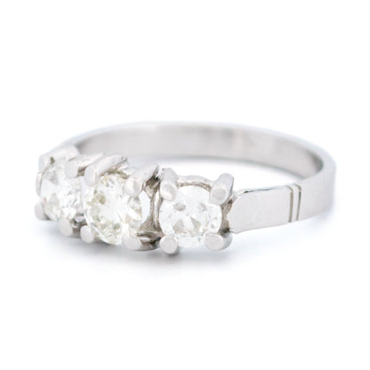 A three stone round diamond ring claw set in platinum
