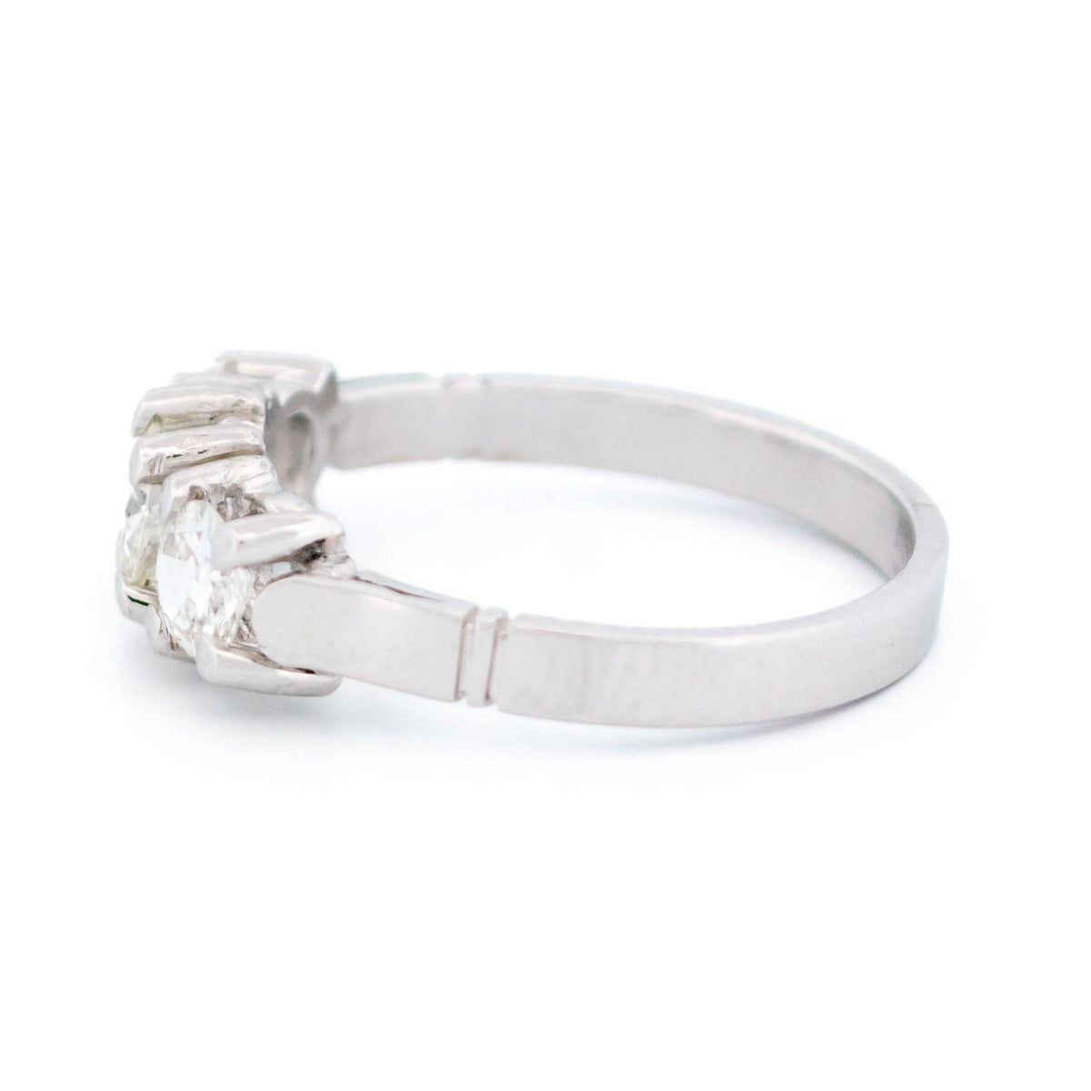 A three stone round diamond ring claw set in platinum