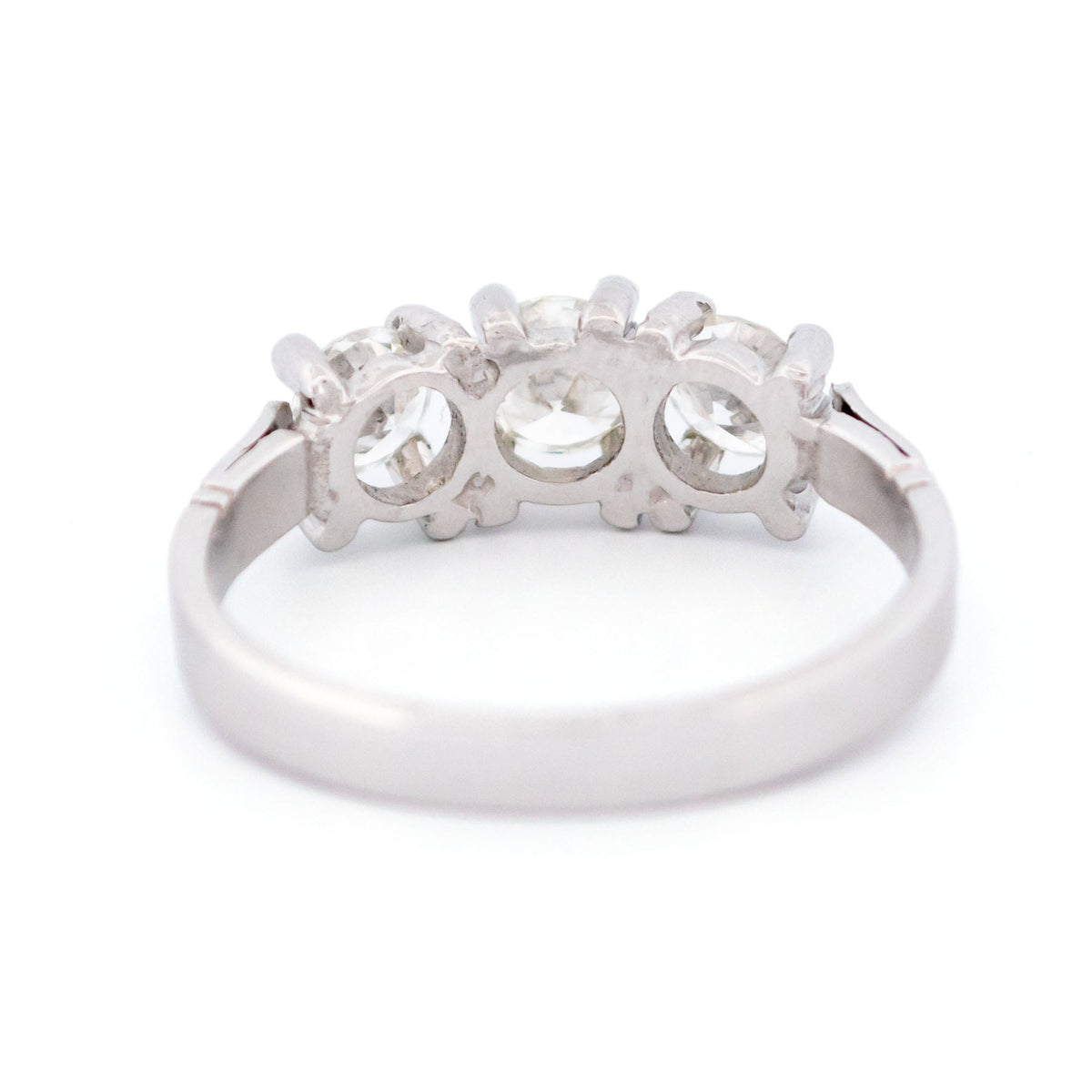 A three stone round diamond ring claw set in platinum