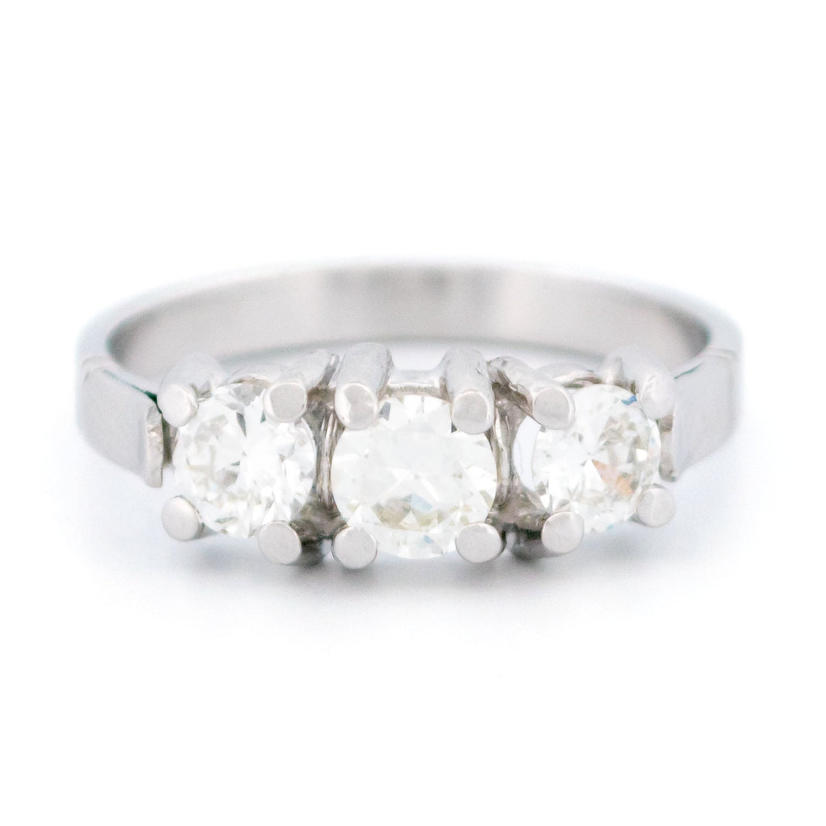 A three stone round diamond ring claw set in platinum