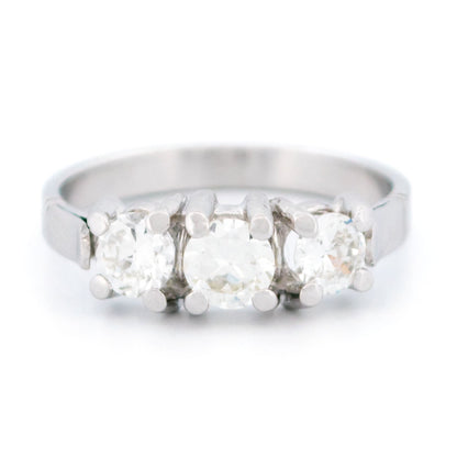 A three stone round diamond ring claw set in platinum
