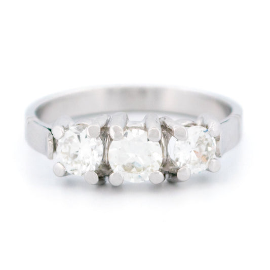 A three stone round diamond ring claw set in platinum