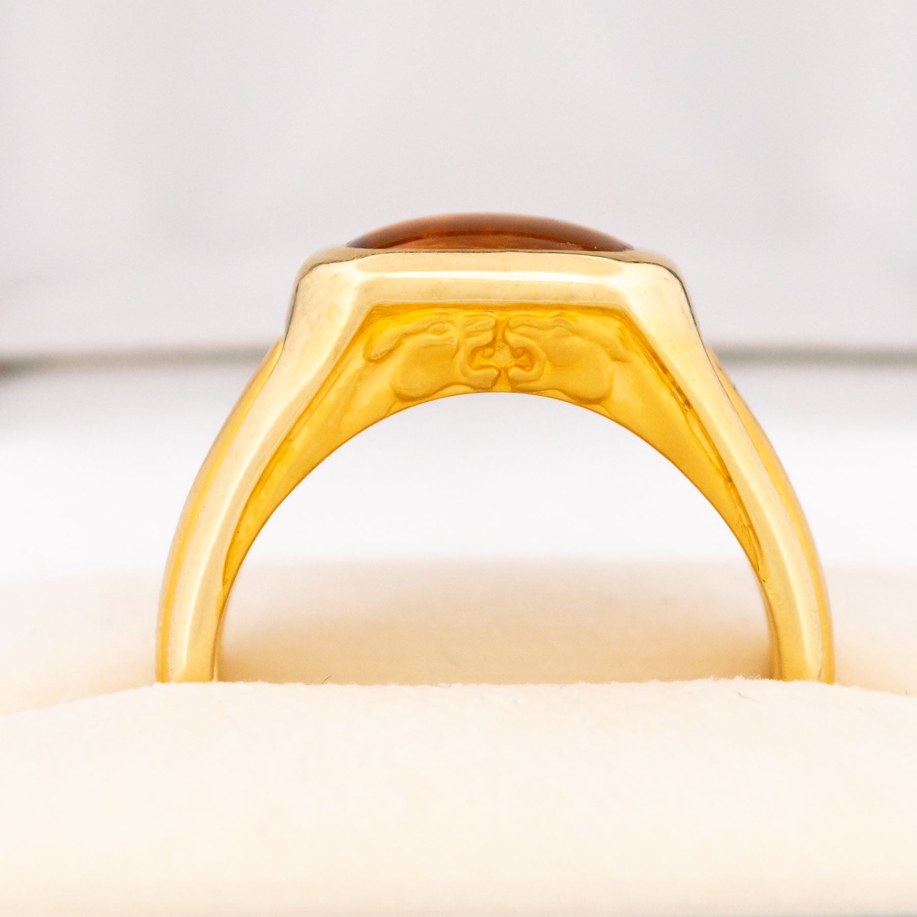 A yellow gold citrine ring, showing two panther heads, in a ring box