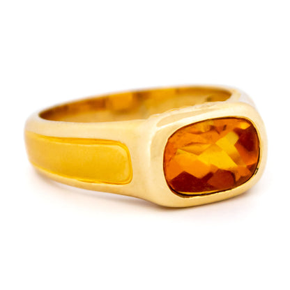 A yellow gold citrine ring, on a white background