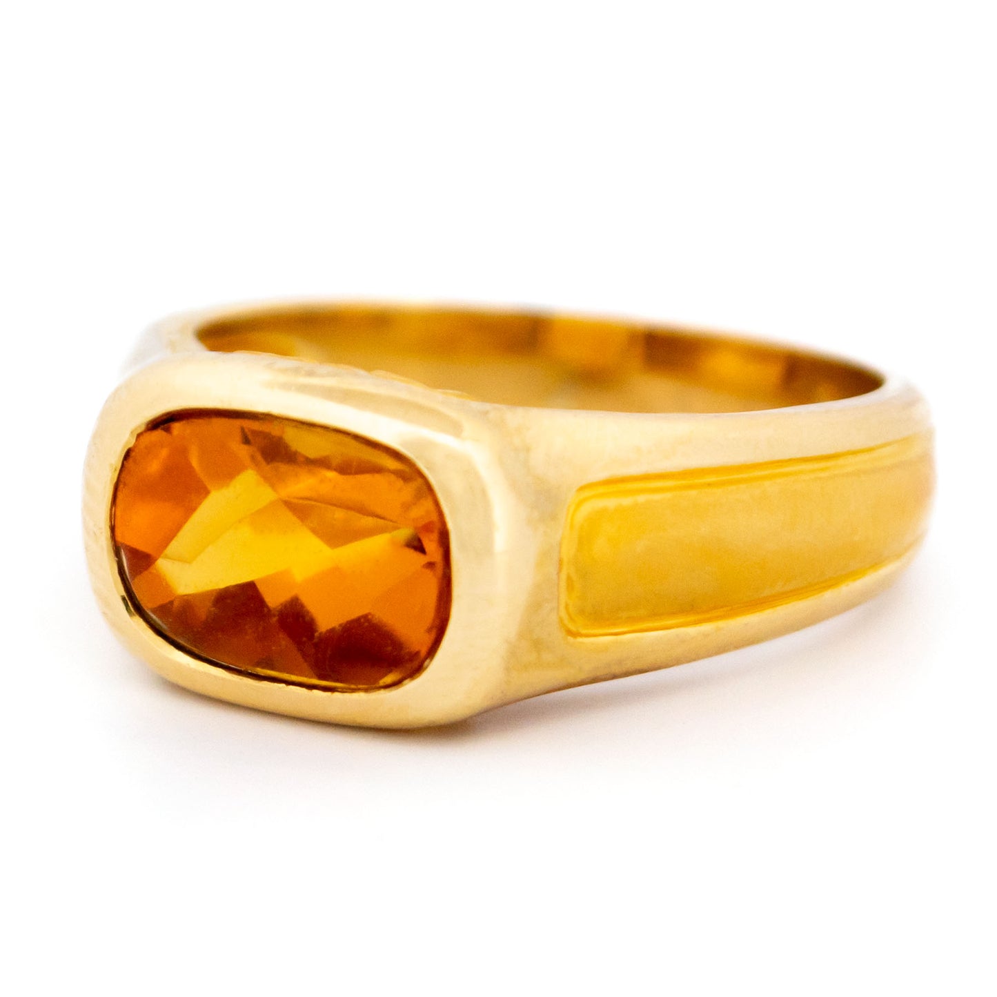 A yellow gold citrine ring, on a whtie background