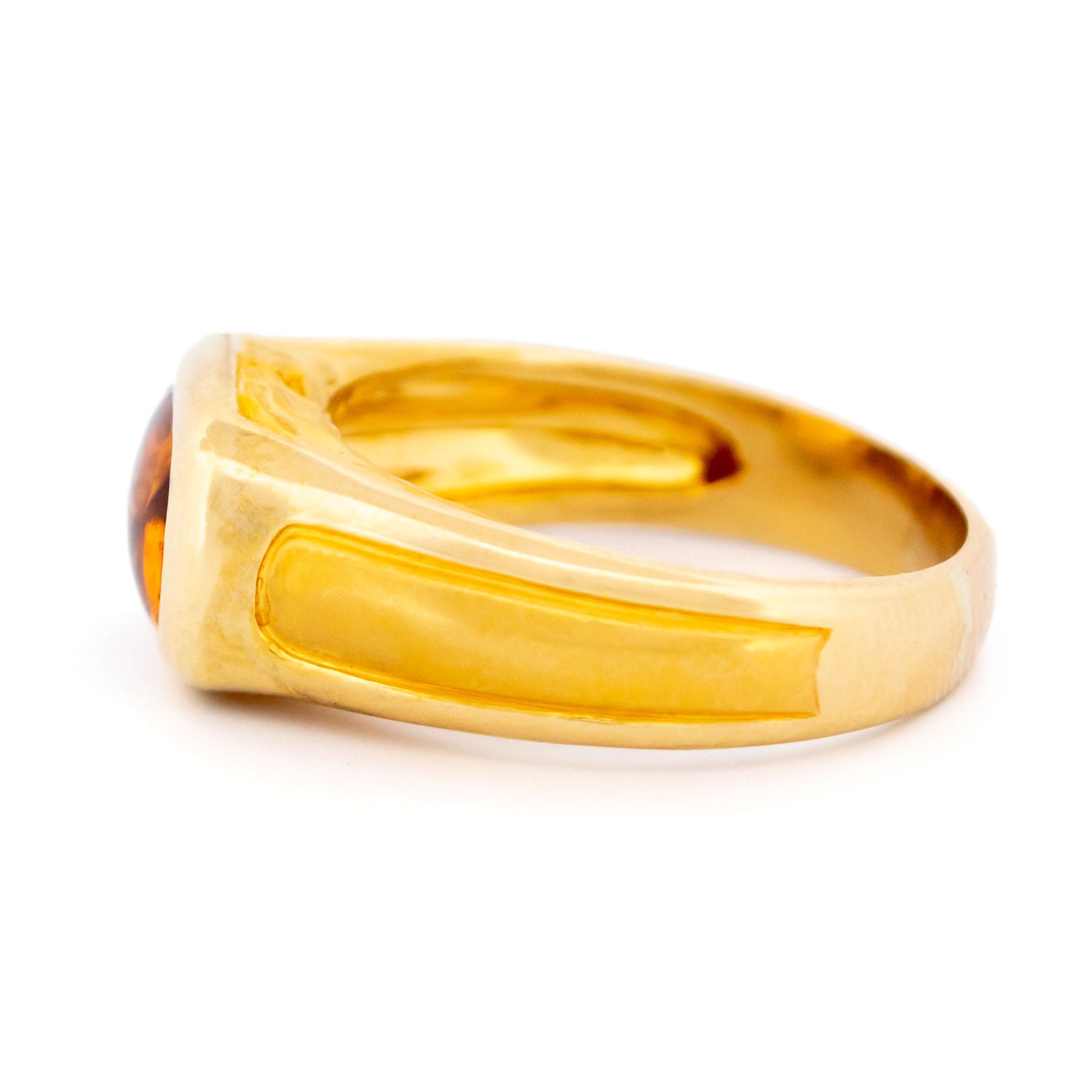 A yellow gold citrine ring, on a white background