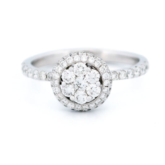 A white gold diamond halo cluster ring, on a white background