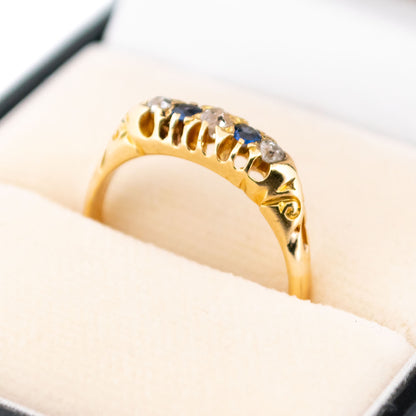 A sapphire and diamond five stone ring in yellow gold, in a ring box