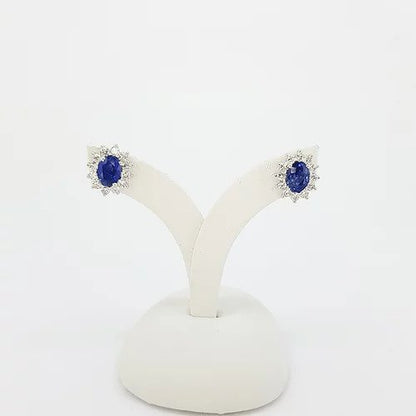 Classic Pair of Sapphire and Diamond Oval Cluster Stud Earrings; 2.21cts oval faceted sapphires surrounded by 0.82cts brilliant cut diamonds, in 18ct white gold