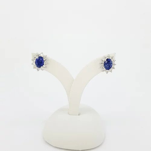 Classic Pair of Sapphire and Diamond Oval Cluster Stud Earrings; 2.21cts oval faceted sapphires surrounded by 0.82cts brilliant cut diamonds, in 18ct white gold