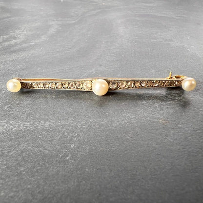 Antique Natural Pearl and Rose Cut Diamond Bar Brooch, set with three button-shape natural white pearls interspaced by 20 rose-cut and two old-cut diamonds in silver upon 18ct yellow gold